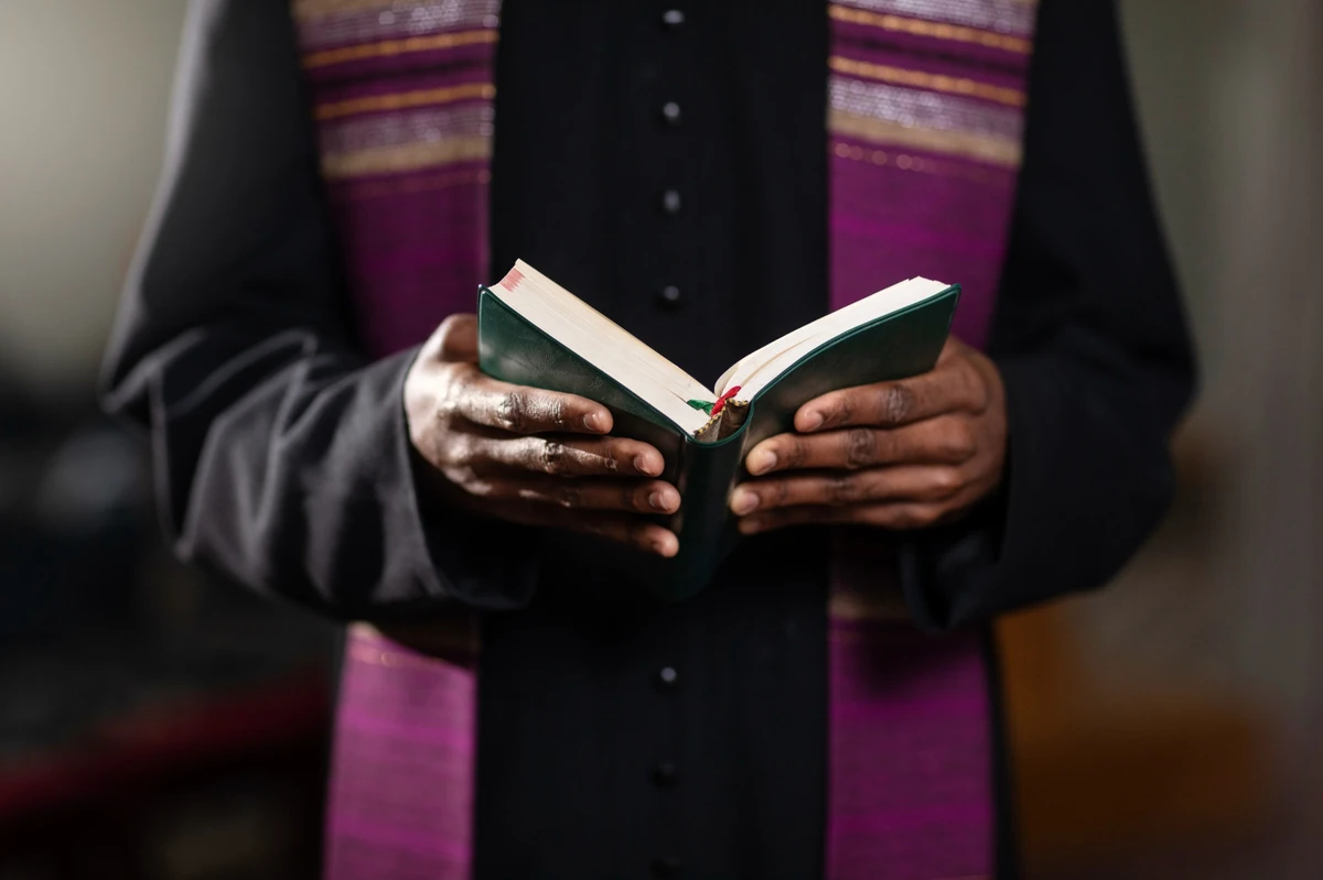 Young Male Priest With Bible Church At Castleton Church Of The Nazarene Church In Indianapolis, IN
